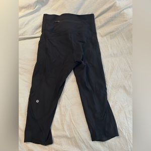 Black crop with mesh on side. Side pockets and back zip pocket